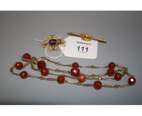 A carnelian and citrine faceted bead necklace on open link gold chain, a naval crown bar brooch marked '9ct' and a garnet and