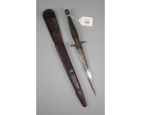 A Fairbairn - Sykes 2nd pattern fighting knife and scabbard with knurled grip, the hilt marked with a broad arrow, 35cm overa