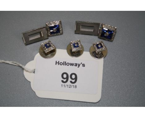 A matched pair of sapphire and diamond cufflinks, comprising two square plaques set with four calibré cut sapphires within a 