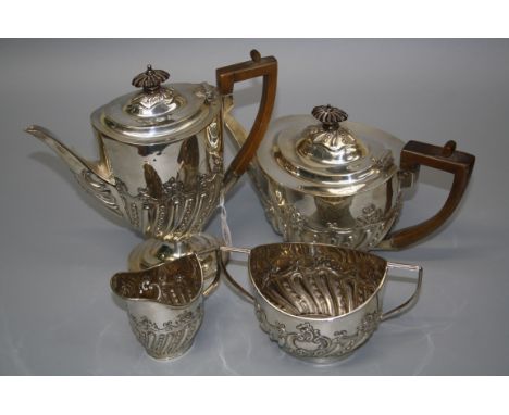 Charles Stuart Harris, a silver four piece tea and coffee service, each of oval form with demi-gadrooned body, floral and bea