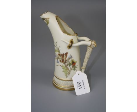 A Royal Worcester jug, design number 1116, with tusk handle, decorated with spring flowers on an ivory and gilt ground,1885, 