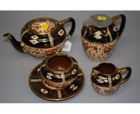 A late Victorian Imari ware part tea service, comprising teapot and stand, hot water pot, cream and sugar