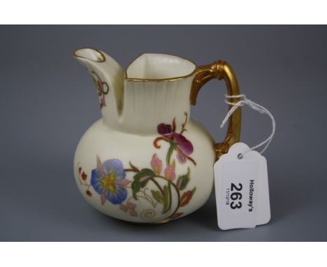 A Royal Worcester squat baluster jug, Design No 1138, decorated with violets and other flowers on an ivory and gilt ground, 9