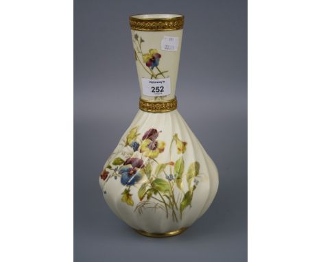 A Royal Worcester vase, with conical neck and wrythen body, decorated with spring flowers on an ivory and gilt ground, Design