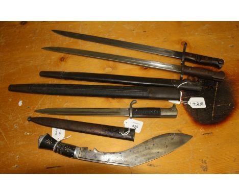 A Remington type bayonet and scabbard, together with one other German bayonet and scabbard and a decorative Kukri