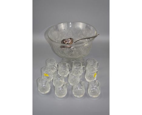 An Edinburgh crystal cut glass punch bowl, together with twelve loop handled cups and a silver plated ladle