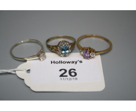 A blue zircon cluster ring, together with an amethyst ring and one other