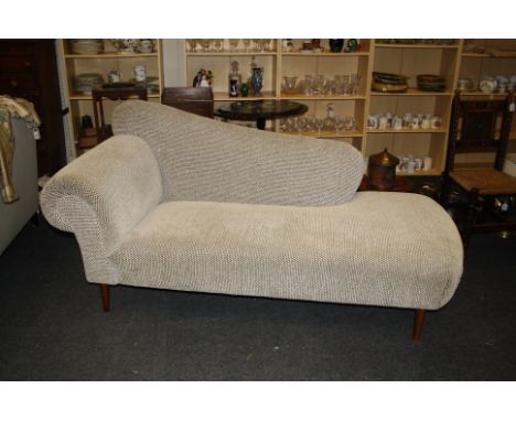 A contemporary Sofa Workshop chaise longue/day bed, upholstered in cut pile black and white check, on turned tapering legs, 1