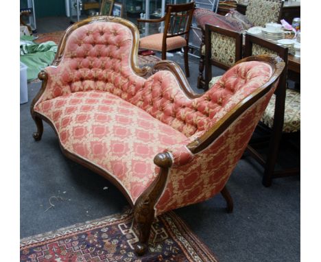 A Victorian-style show wood frame camel back salon settee, with pomegranate and acanthus carved rail, button upholstered back