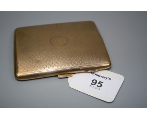 An Art Deco 9ct gold cigarette case, the engine turned slightly convex case with vacant circular cartouche to centre, push bu