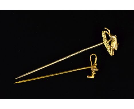 TWO STICKPINS, the first a gold plated stick pin depicting a running hare, the second a fox's head and a riding crop, stamped