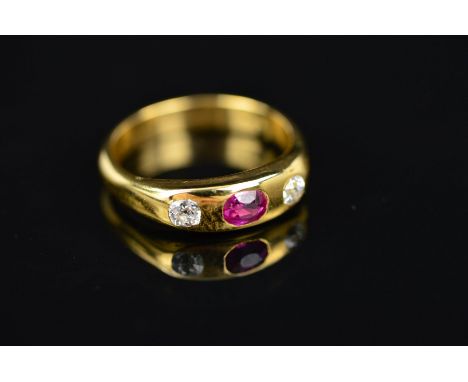 AN EARLY 20TH CENTURY RUBY AND DIAMOND THREE STONE RING, one oval mixed ruby, two Old European cut diamonds, estimated total 