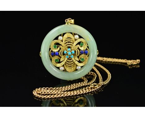 A 9CT GOLD JADE AND MULTI GEM PENDANT AND CHAIN, the pendant of circular outline, the central 9ct gold panel of floral design