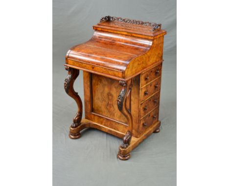 A VICTORIAN BURR WALNUT PIANO TOP DAVENPORT, fret carved moulding to the pop up top which encloses four pigeon holes and thre