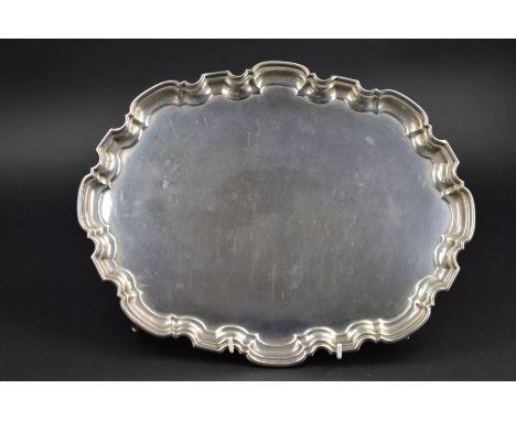 AN ELIZABETH II OVAL SILVER SALVER, pie crust edge, on four scrolled feet, makers Adie Brothers Ltd, Birmingham 1963, approxi