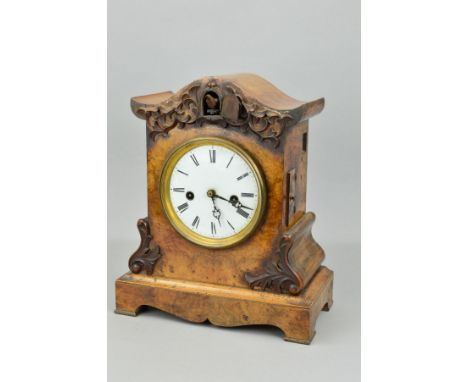 A VICTORIAN BURR WALNUT CUCKOO MANTEL CLOCK, applied foliate carving to the domed top and scrolled sides, circular white enam