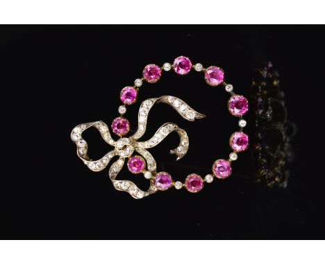 A LATE 19TH CENTURY GOLD RUBY AND DIAMOND BOW BROOCH, the Old European and Old Swiss cut diamond set bow is entwinned within 