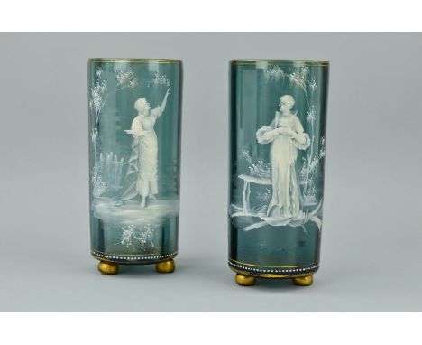 A PAIR OF LATE 19TH CENTURY MARY GREGORY STYLE BLUE/GREY GLASS VASES, of ribbed cylindrical form, the white enamel depicting 