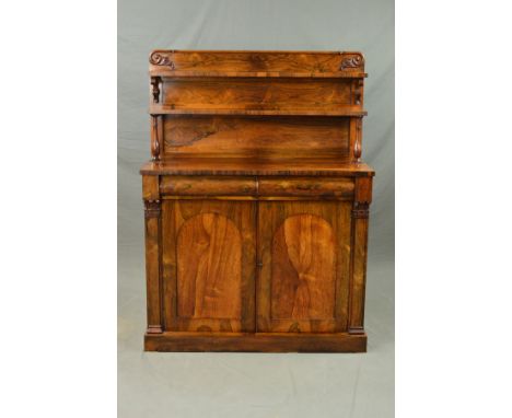 A VICTORIAN ROSEWOOD CHIFFONIER, the rectangular back with moulded top edge terminating in foliate carved scrolls above two s