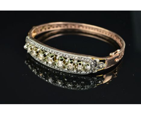 A DIAMOND SET OVAL HINGED BANGLE, rose cut diamonds set to one half graduating in size from 1.0mm to 3mm in diameter, estimat