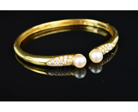 A MODERN 18CT GOLD PICCHIOTTI DIAMOND AND CULTURED PEARL TORQUE DESIGN BANGLE, an oval bangle with one hinge section, pave se