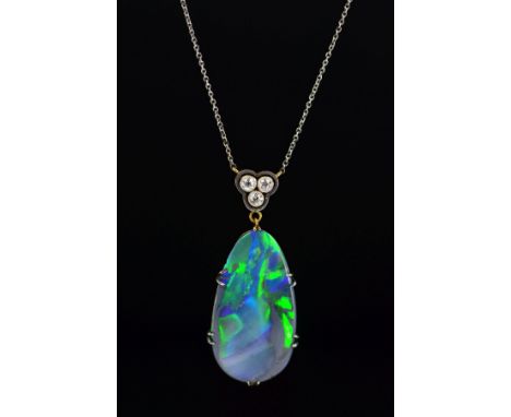 AN EDWARDIAN BLACK OPAL AND DIAMOND PENDANT, oval shape opal double claw set measuring approximately 28mm x 15mm, opal displa