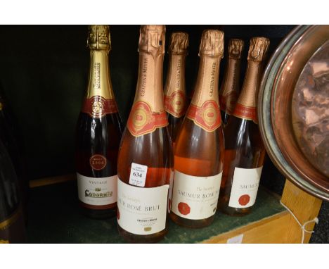 Eight bottles of rose sparkling wine.