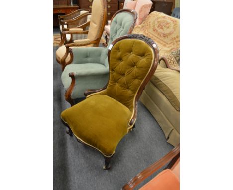 A Victorian mahogany framed button upholstered nursing chair.