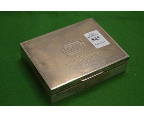 An engine turned silver cigarette box.