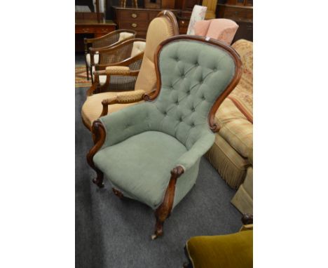 A Victorian mahogany framed button upholstered armchair.