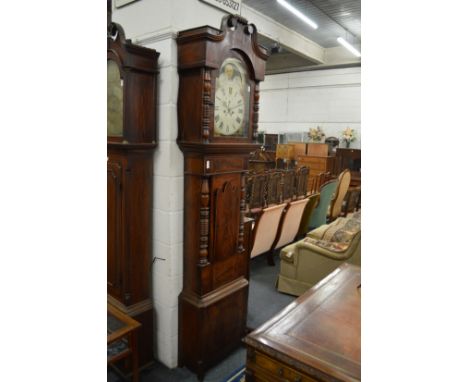 A large 19th century mahogany longcase clock with painted arched dial and moon phase movement.