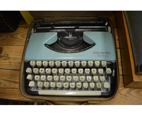 An Olympia Splendid 99 typewriter and a sewing machine.