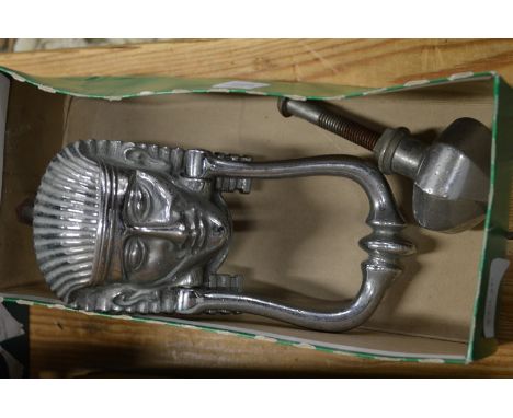 An Egyptian revival chrome plated door knocker and similar door knob.