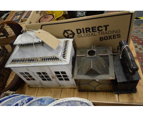 An old box iron, a lantern and other items.
