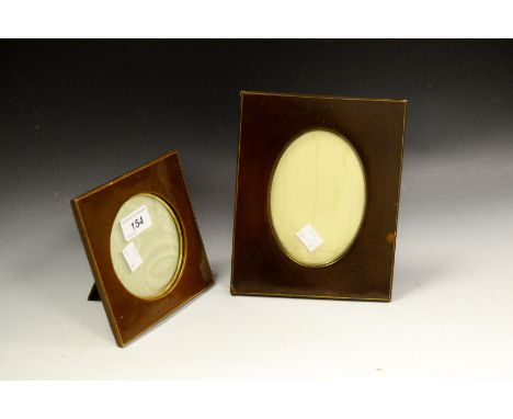 An early 20th century leather easel photograph frame, retailed by Finnigans Ltd, London, Manchester & Liverpool, c.1920; anot