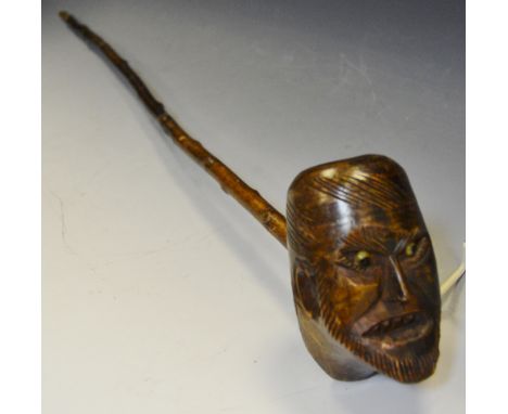 A 19th century folk art pipe, carved with a bearded face