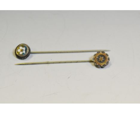 An Edwardian silver and enamel stick pin, decorated with a primrose; another, silver and gold coloured metal (2)