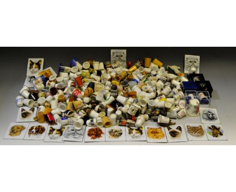 A collection of enamel plaques, printed after Derick Bown with Dogs and Cats; a collection of thimbles