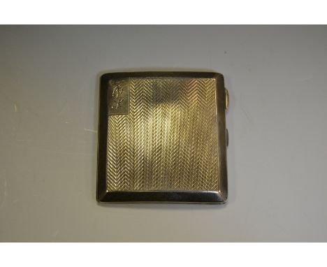 A George V silver cigarette case, engine turned with bands of chevrons, gilt interior, S Blanckensee & Sons Ltd, Birmingham 1