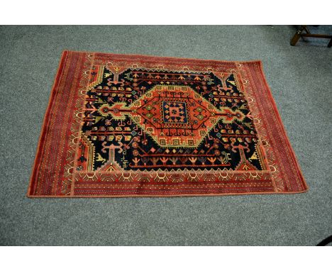 A Hamadan , Iranian Kurdistan, carpet, midnight blue field, central geometric medallion within multiple stripe border, 1.90m 