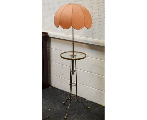 An Art Deco standard lamp, a circular glass tier above graduating ring supports, tripod legs terminating in ball feet c.1940 