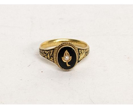 A Victorian yellow metal mourning ring inset with a single seed pearl, 4.1g Location: