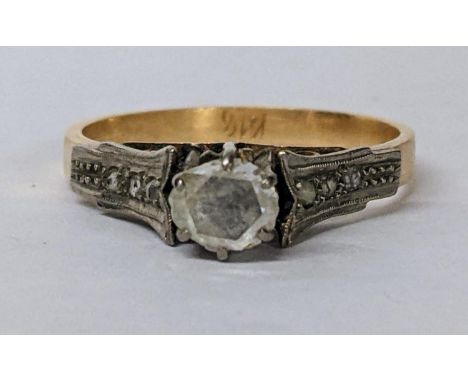 A yellow and white metal diamond ring with diamond chip shoulders Location: 