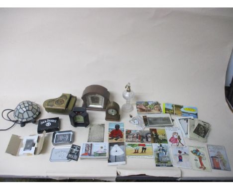 A mixed lot of items to include an Enfield mantel clock, and other clocks, various postcards, including humorous cards, glass