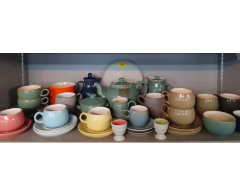 Mixed Denby pottery, mainly teacups with saucers, in various styles and colours, together with an orange Le Creuset pot Locat