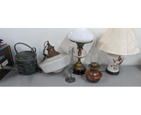 A group of lamps to include two oil lamps, a ceiling light shade and others along with a watering canLocation: 