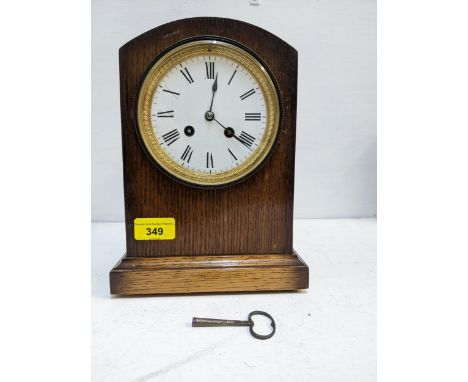 An Edwardian 8-day oak cased mantel clock with white enamel Roman dial, a Japy Freres movement, striking on a bell, with key 