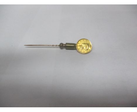 A yellow metal 1861 large Indian head dollar mounted on a stick pinLocation: 