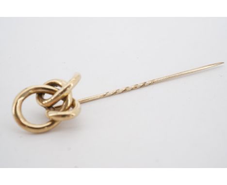 A Victorian yellow metal stick pin, its terminal in the form of an open knot, 9.5 cm, 6.2 g