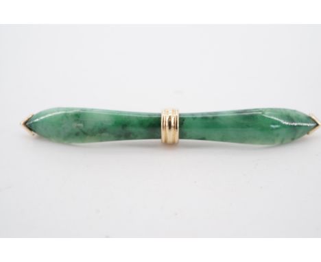 A 9 ct gold mounted jade bar brooch, the spinach jade carved in the form of an archer's bow and set  with a reeded collar bet